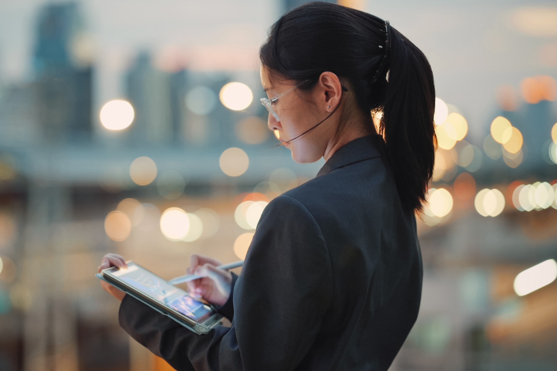 Asian business analyst using tablet