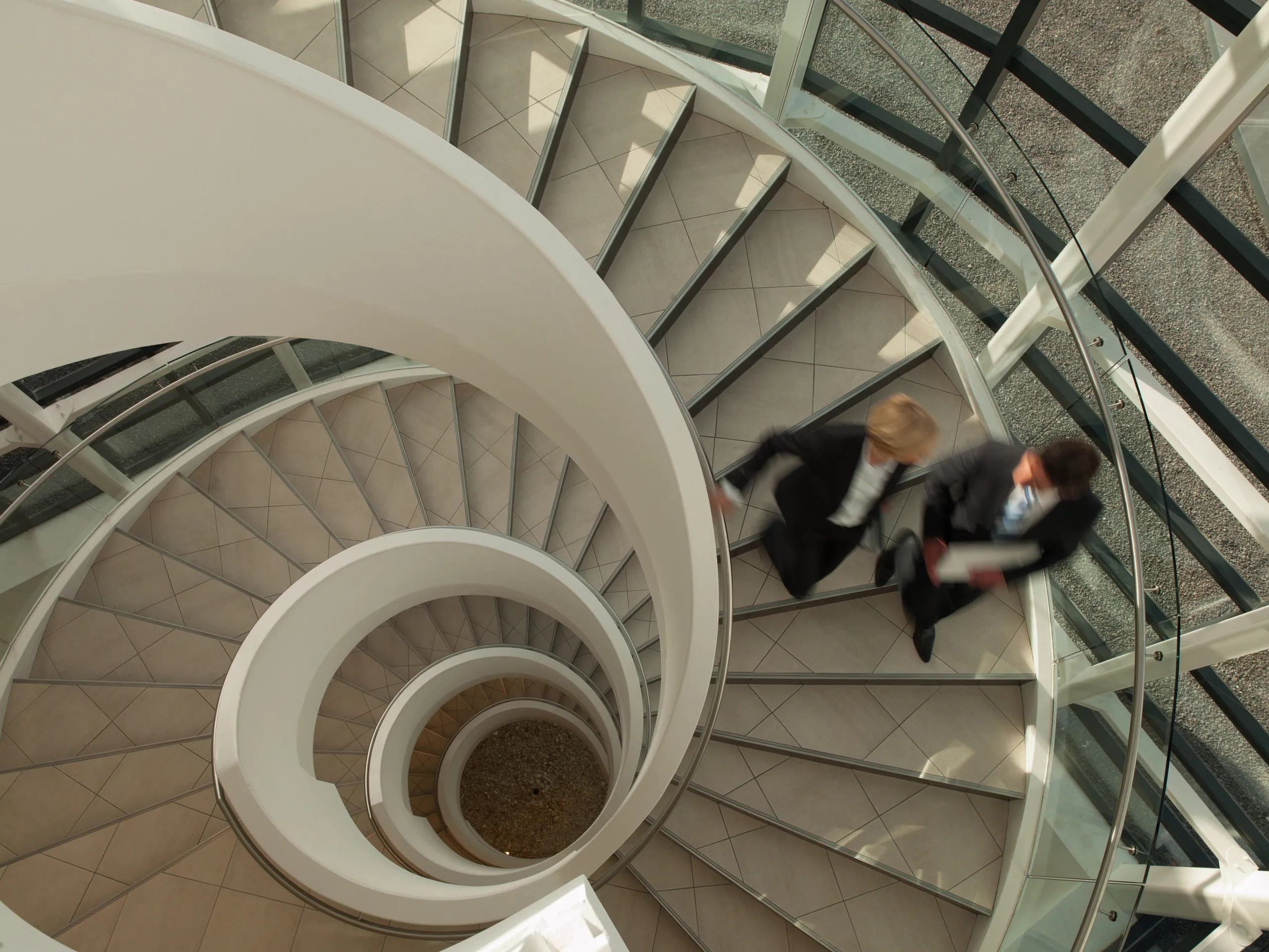 Business professionals spiral staircase