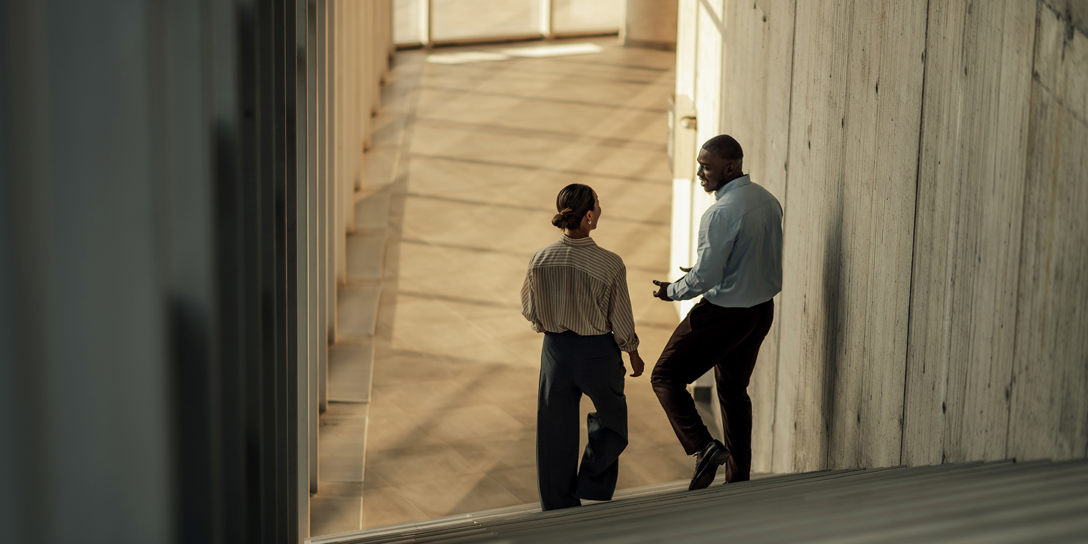 Executive colleagues private stairway conversation