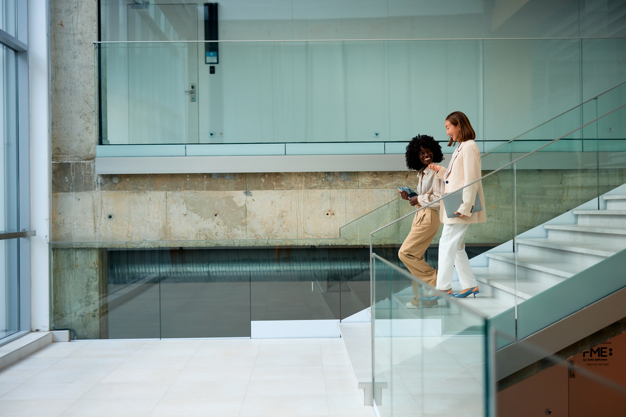 Female professionals office stairway conversation