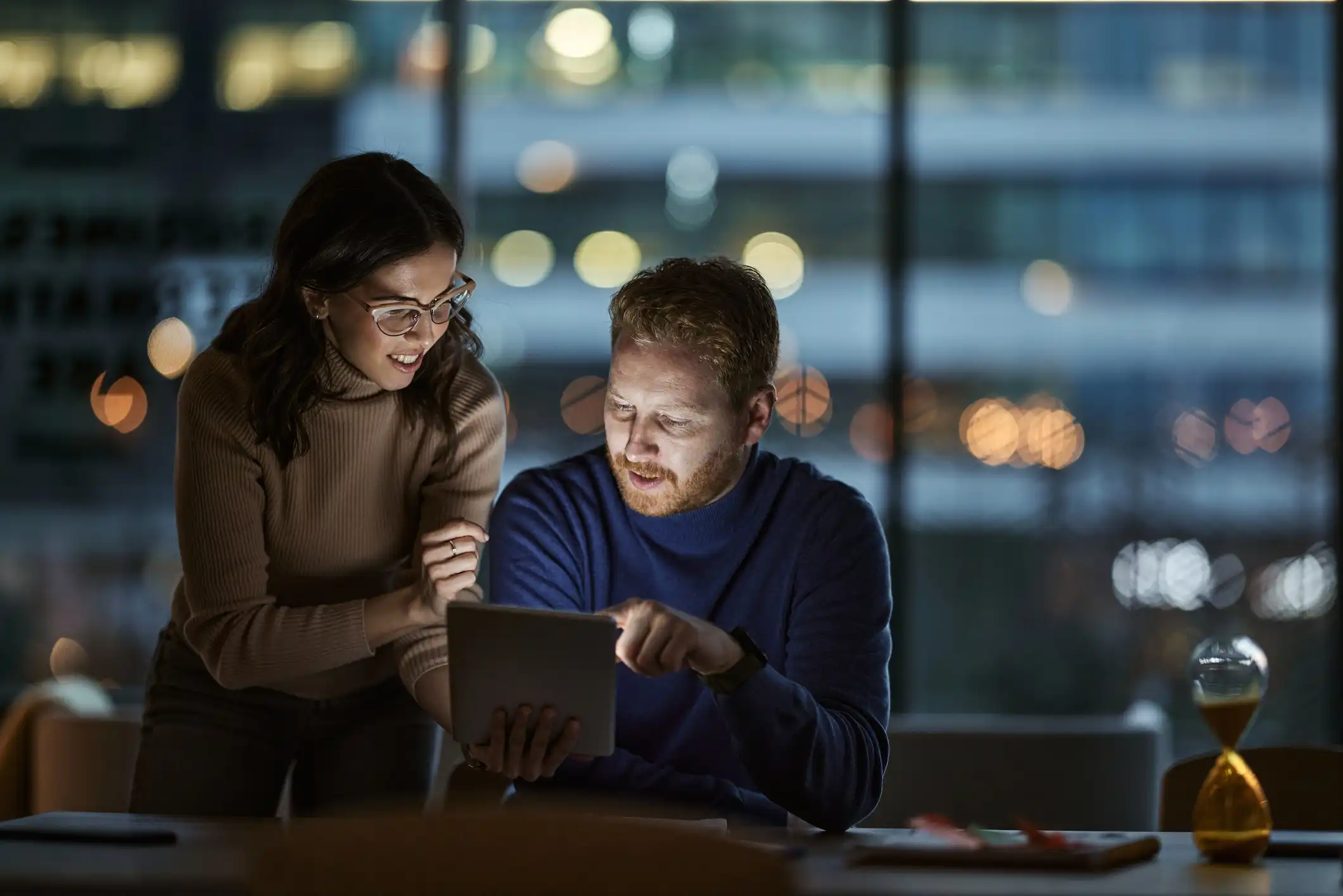 Colleagues analyzing information together after hours