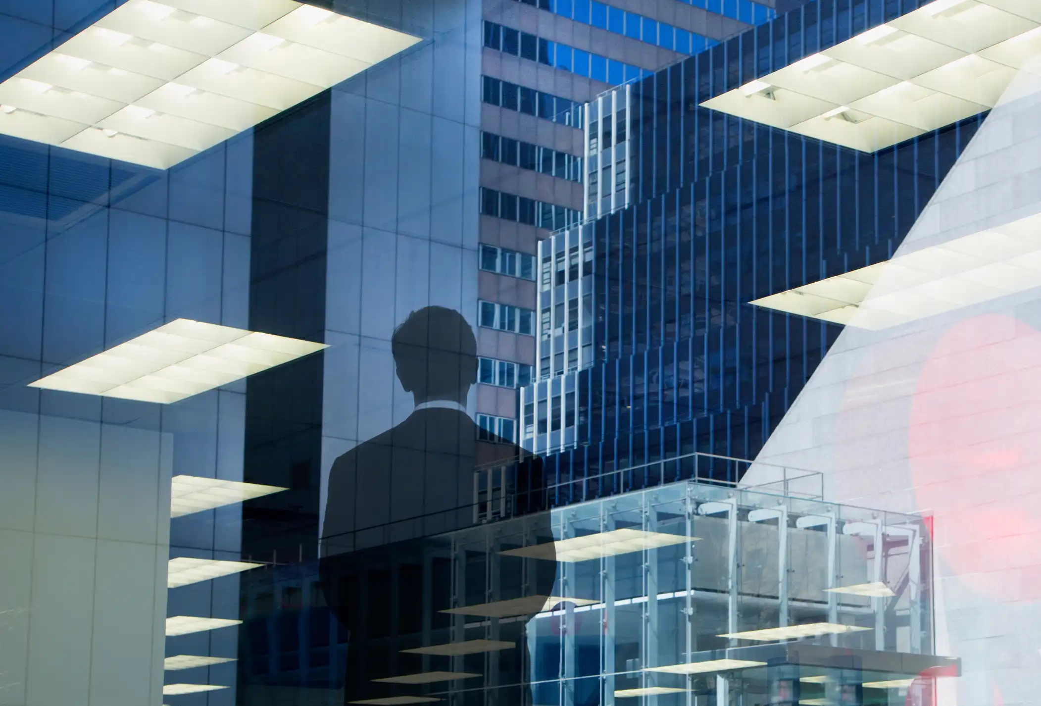 Executive silhouette reflected in a modern office window