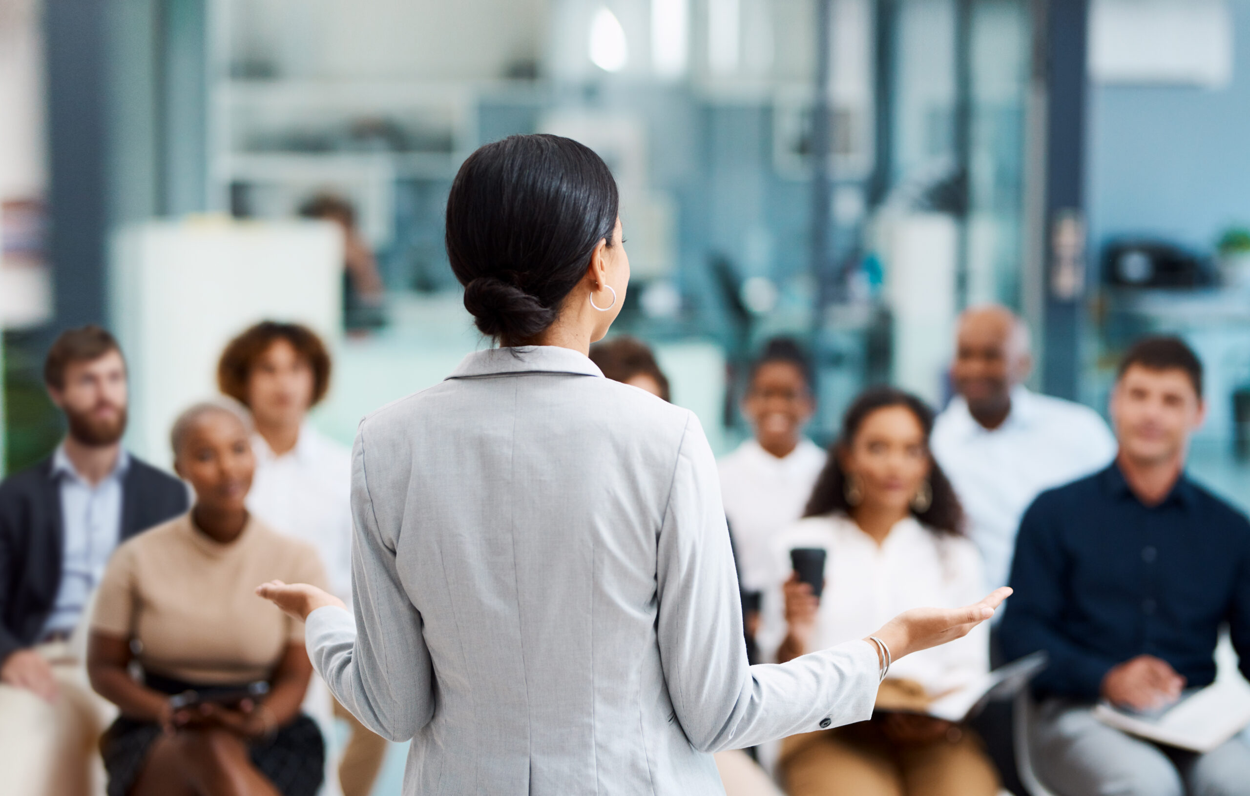 Female executive leading a C-suite team discussion about mandate alignment