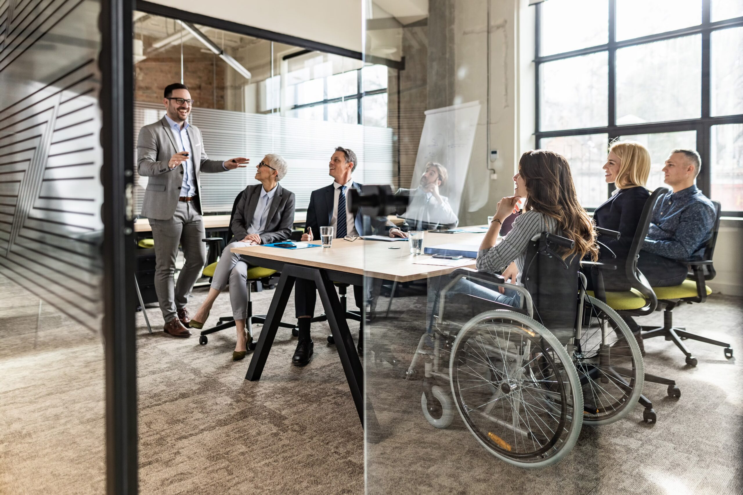 Inclusive leadership team meeting in a boardroom