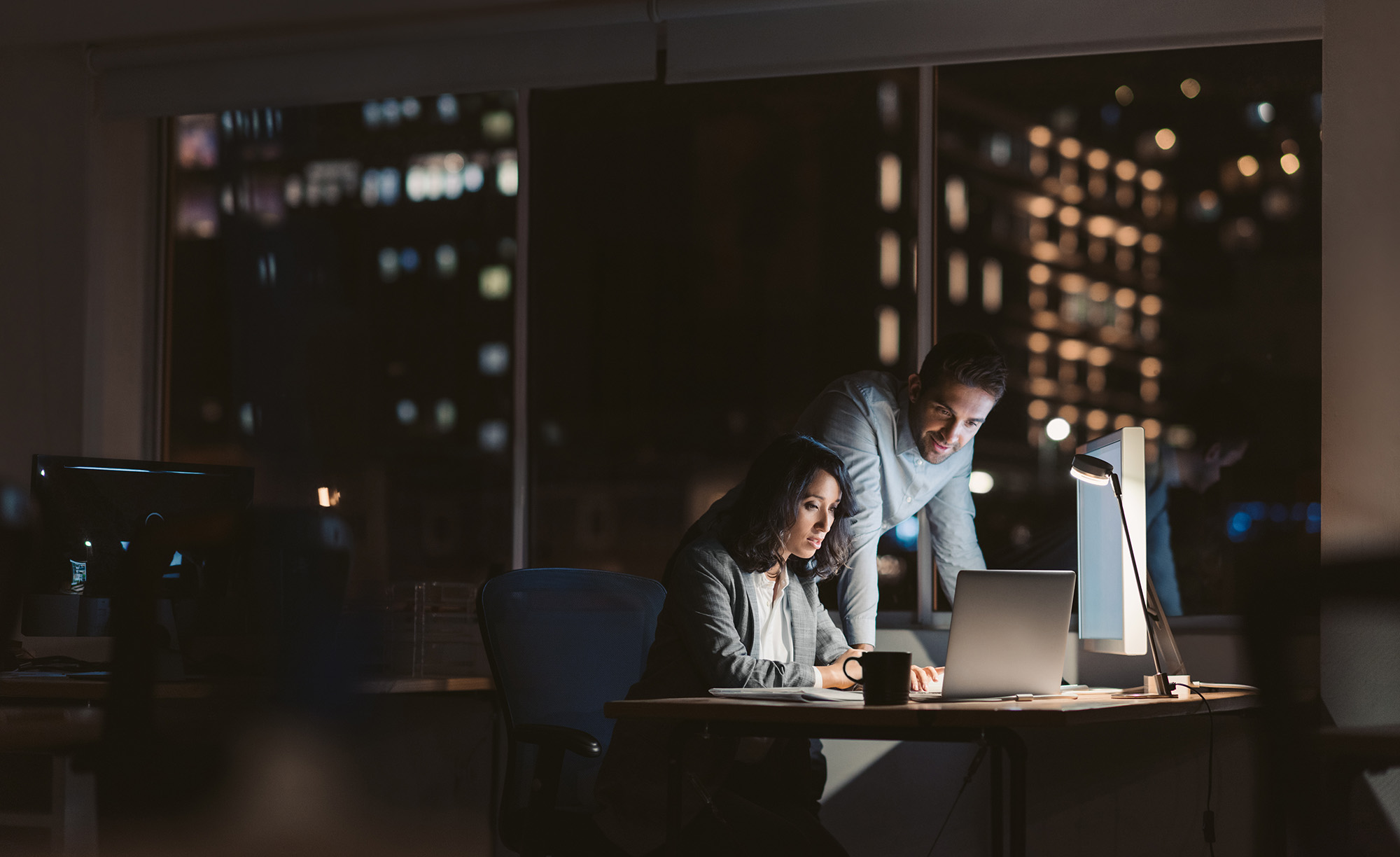 Team working through a complex business problem after hours