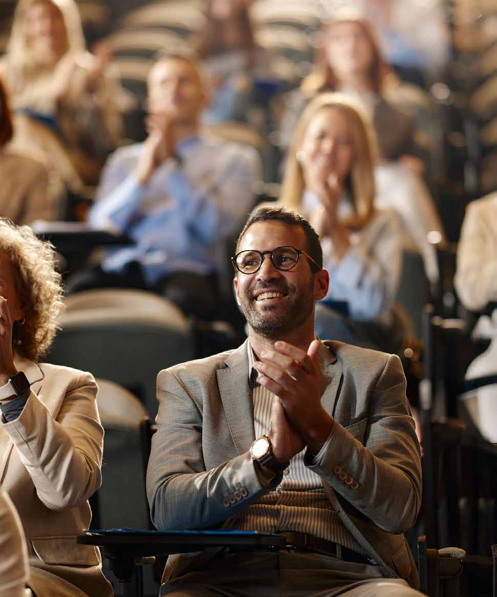 Business leader at a conference representing successful leadership outcomes
