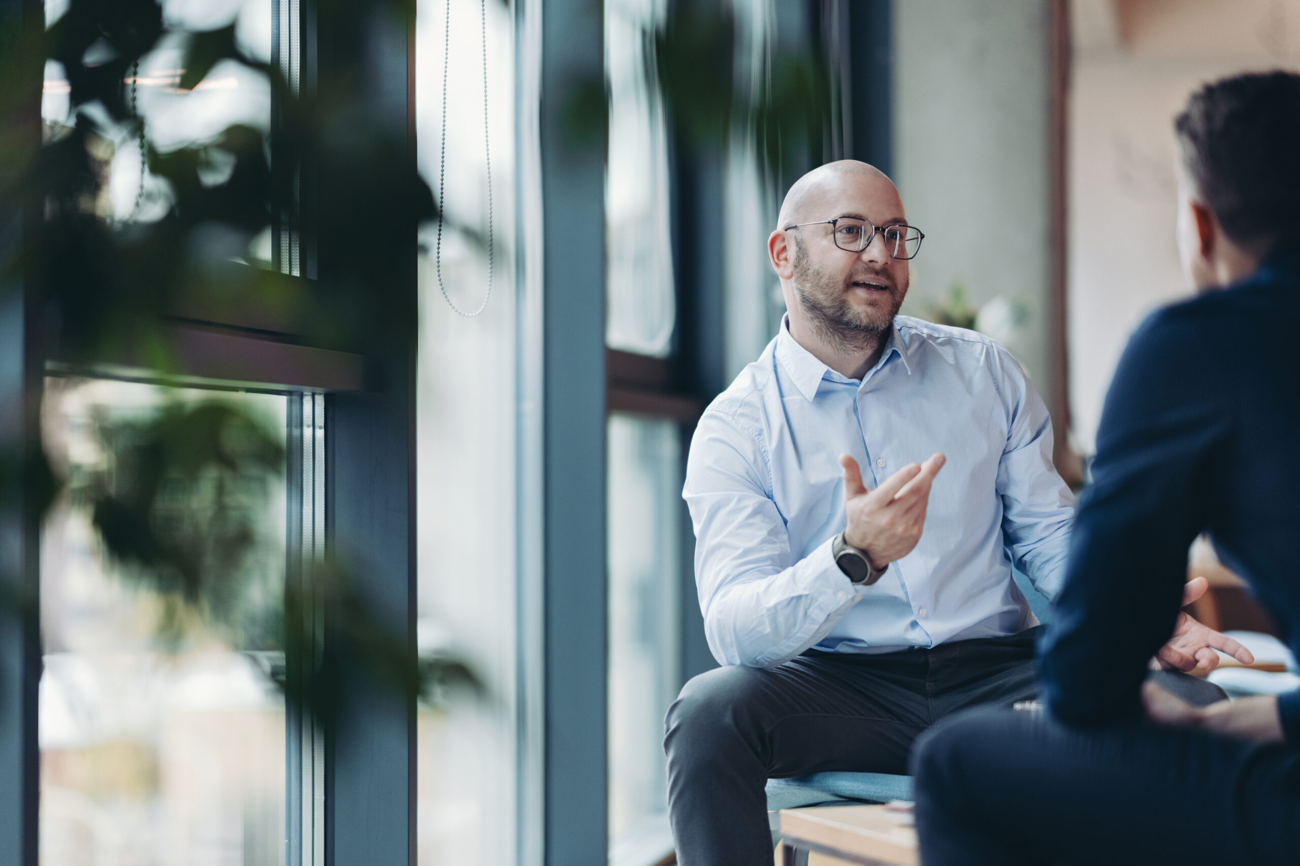 Two executives discussing leadership in a private meeting