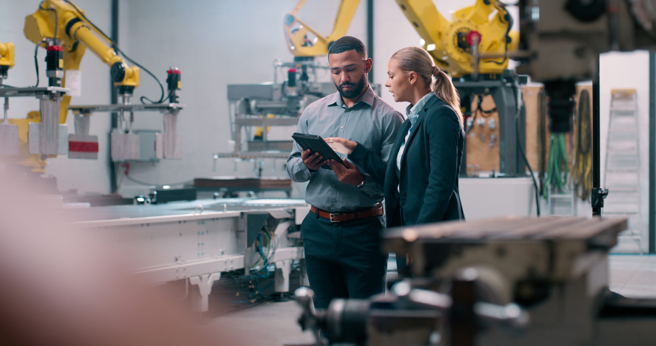 Manufacturing professionals reviewing robotic automation